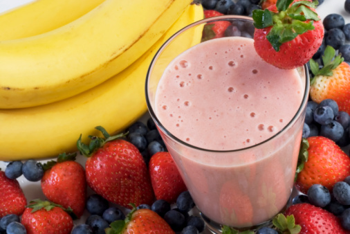 Smoothie surrounded by fruits